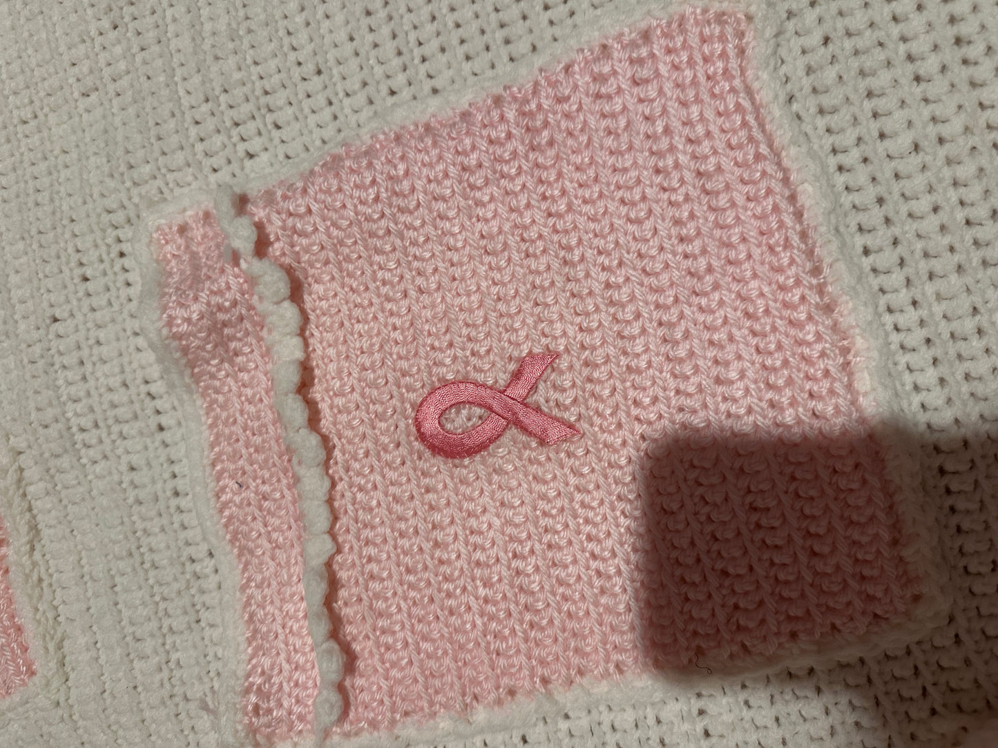 Handmade crocheted, white and pink breast cancer blanket with pockets