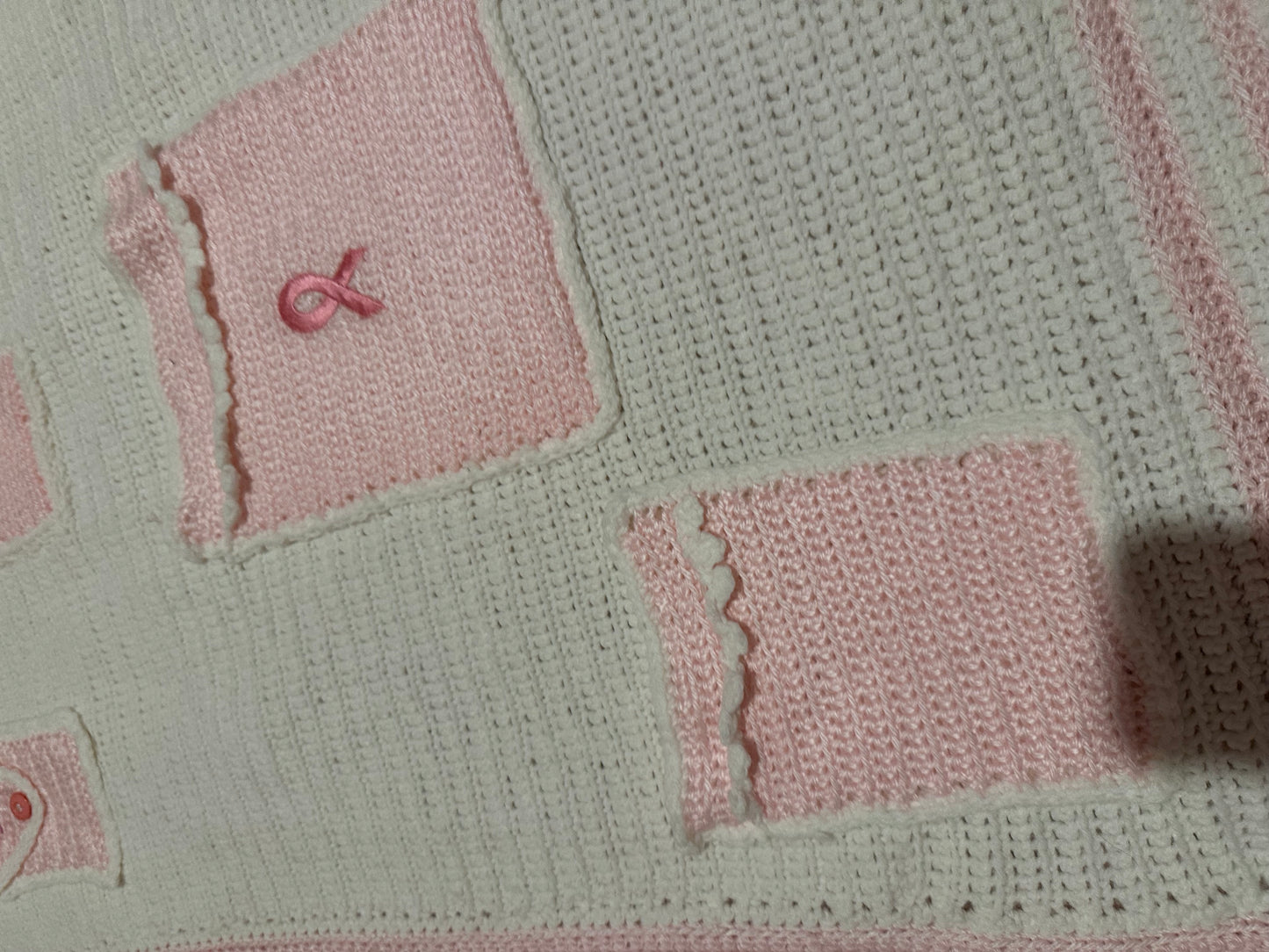 Handmade crocheted, white and pink breast cancer blanket with pockets
