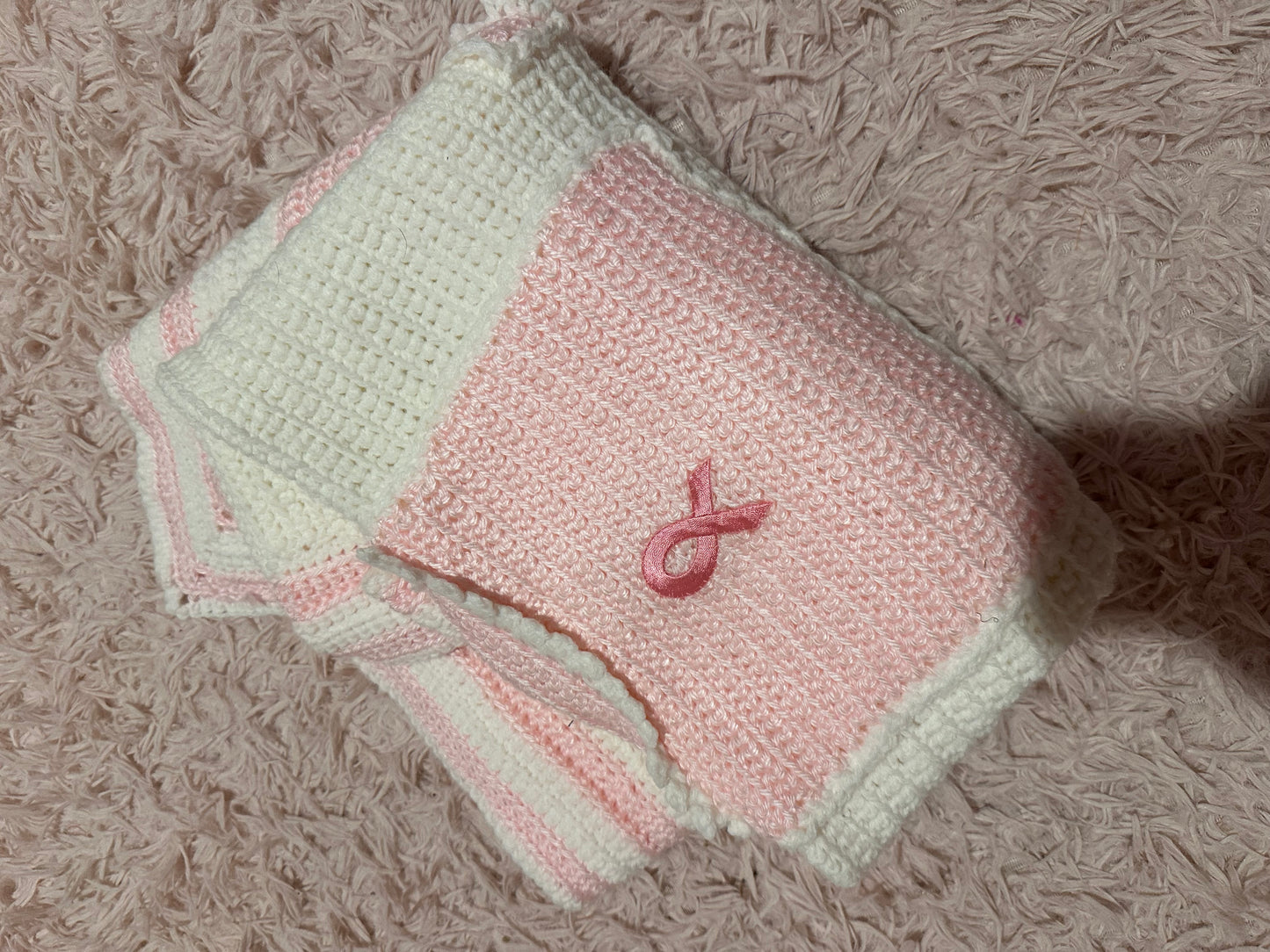 Handmade crocheted, white and pink breast cancer blanket with pockets
